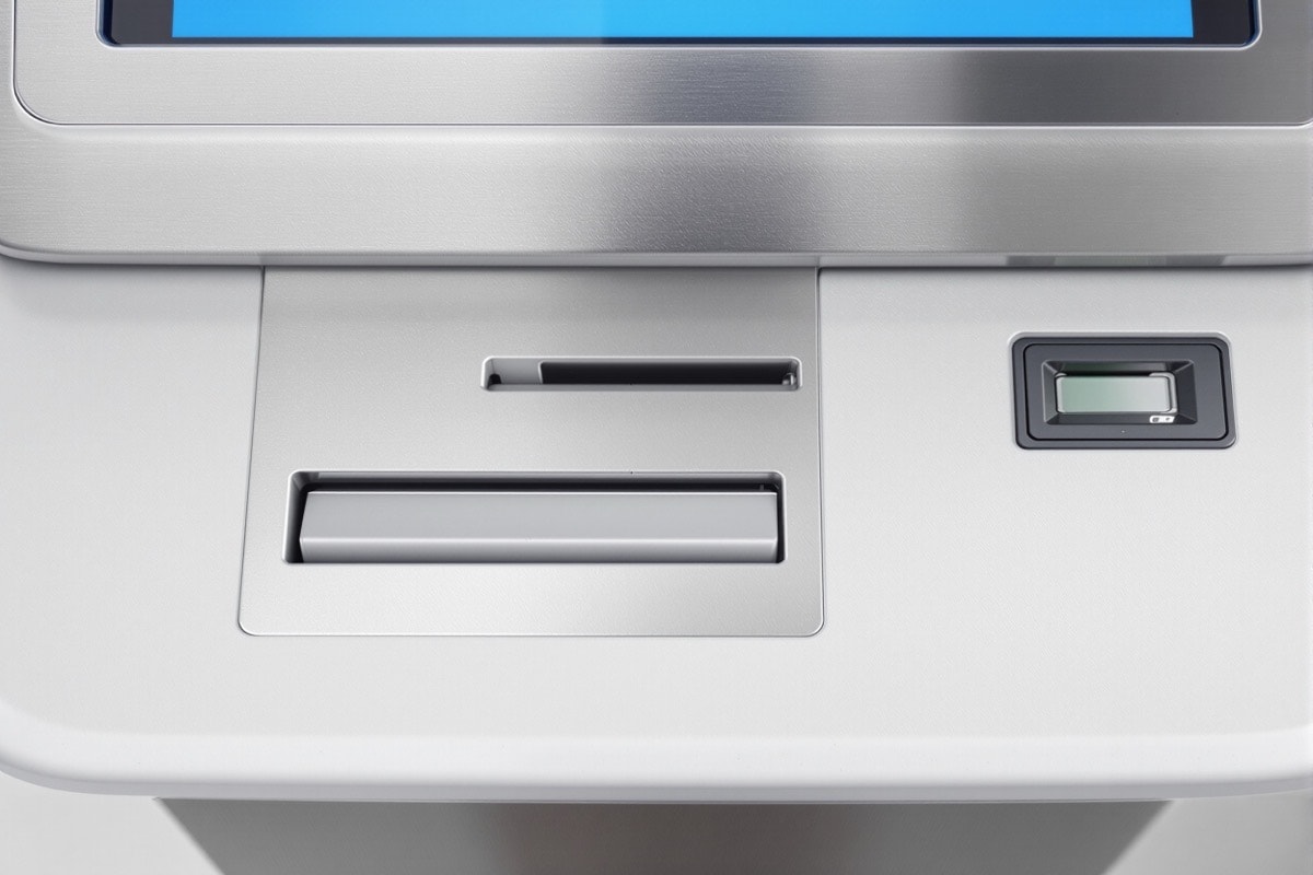 Detail of an unbranded kiosk fascia showing scanner, card reader and document slot